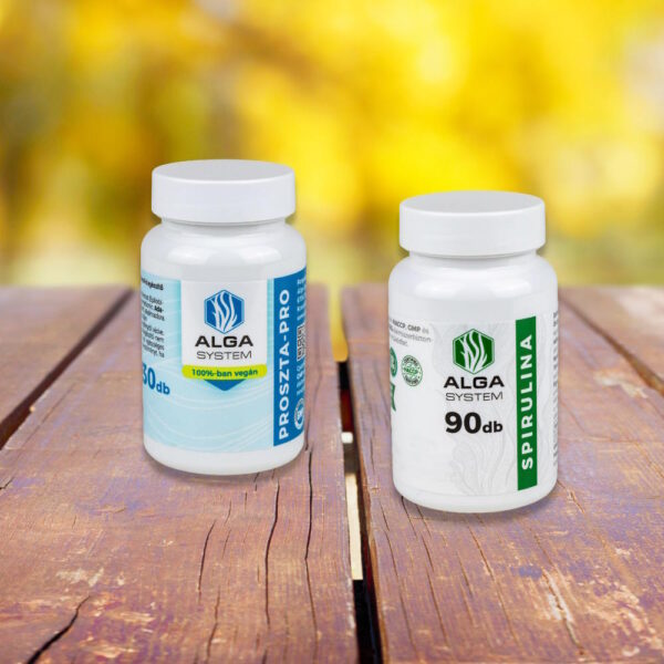 Alga System Prosztata-Pro és Spirulina kapszulák fehér műanyag dobozban, fapadlón, őszi színekben elmosódott háttérrel.